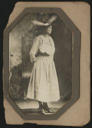 Standing woman wearing hat