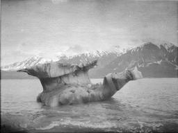 Stranded iceberg with embedded and suspended debris - on beach at Indian Camp
