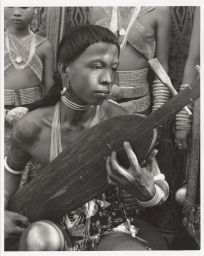 Man playing sapo stringed instrument