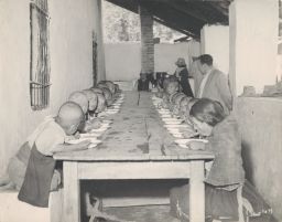 School children at the hot lunch school program in the renovated building