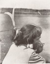 Woman With Ear Spool and Feather