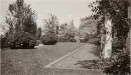 Lawn at rear of mansion, partial view of mansion to the right