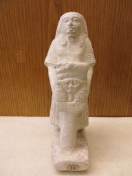 Egyptian statuette of standing figure with stylized sistrum