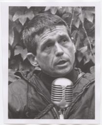 Daniel Berrigan talking into a microphone