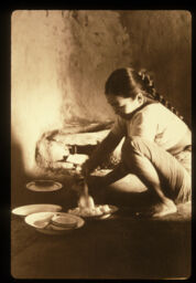 Khana ko tayari gardai mahila (खानाको तयारी गर्दै महिला / A Woman serving meal)