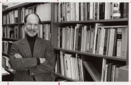 Professor Michael Kammen standing by a shelf of books