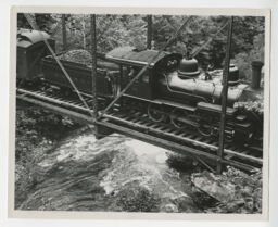 Engineer Sherman Pippin and unidentified trainman in Locomotive 10 on ET&WNC on a bridge crossing a river