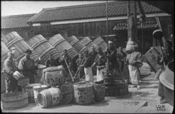 Several workers employed in the manufacture of sake