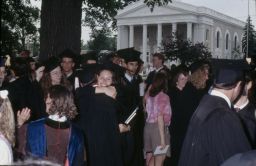 Faculty, students, and guests mingle on Main Hall Green for Commencement