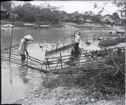 Two men in a duck farm on Pasig River
