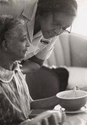 Homemaker service aide talking to an elderly woman