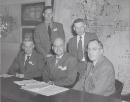 Paul G. Oppermann sitting at a table with four colleagues