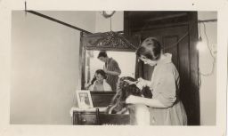 One Woman Giving a Haircut to Another Woman
