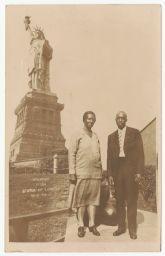 Man and woman in front of the Statue of Liberty