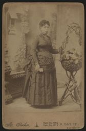 Woman standing next to flower basket