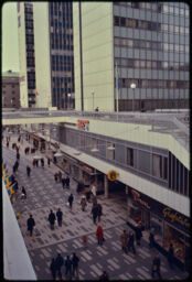 Pedestrian shopping street from above, showing an overpass, stairs, and the main thoroughfare (Hötorget, Stockholm, SE)