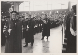 Cornell president James A. Perkins (second left) in Barton Hall at Centennial celebration