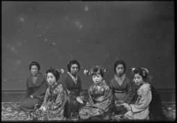 Several seated geishas