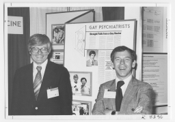 Two men standing in front of a gay psychiatrists display