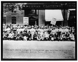 "Strike against reduction in wages of 10 to 40 percent after having been out for 8 weeks.  Schwab's Clothing Factory, St. Louis, MO. May 1912" "Liberty Service" "Strike Series" Men and women pose with strike placards in front of the Schwab Clothing Company building