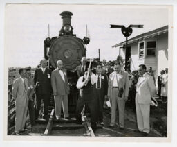Major General Carl R. Gray Jr. drives the golden spike for the Shenandoah Central Railroad while others look on