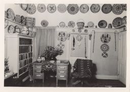 Photograph of Native American baskets displayed above a desk.