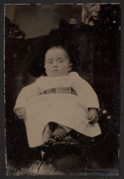 Baby with nurse standing behind