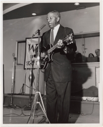 Lonnie Johnson singing with guitar