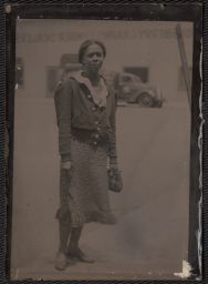 Woman standing with car in the background