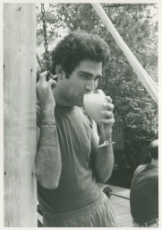 Man drinking by hammock on Fire Island trip