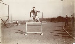 Alvin Christian Kraenzlein (1876-1928), D.D.S. 1900, running the  hurdles, practice on the field
