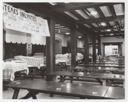 Mattresses and blankets on tables in Willard Straight dining hall.