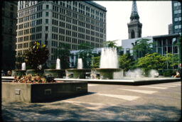 Five fountains with the Pittsburgh skyline in the background. (Mellon Square, Pittsburgh, Pennsylvania, USA)