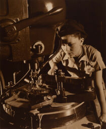 [Woman working at a machine]