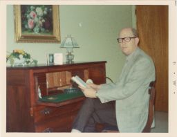 Photo of Archie Ammons in office at home.
