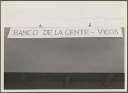 Sign reads "Banco de la Gente- Vicos"