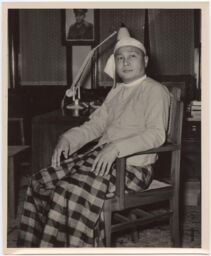 U Nu, seated with photo of U Aung Sun hanging in background