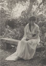 Signe Guerdrum Sitting on Stone Bench in the Woods