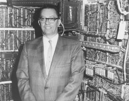 Herman Lukoff  (1923-1979), B.S. in E.E. 1943, with UNIVAC circuitry in background