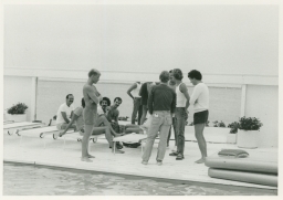 Men by poolside next to ocean on Fire Island trip
