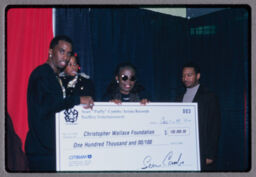 P. Diddy with check for the Christopher Wallace Foundation