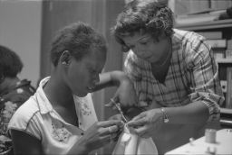 Two women at a sewing machinge