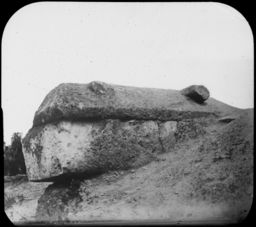 Stone coffin eroding out of burial mound