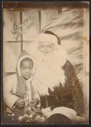 Child sitting with Santa Claus