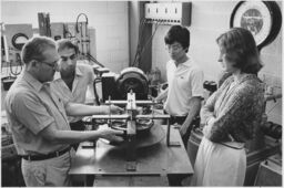 Portrait of Simpson (Sam) Linke, Cornell Professor of Electrical Engineering, with unidentified students