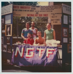 Five men at a National Gay Task Force booth