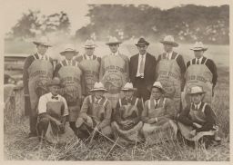 Men wearing aprons made from Quaker Hill Farm feed sacks.
