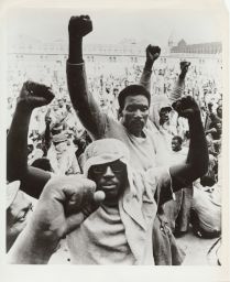 Men raising fists during the Attica Prison uprising