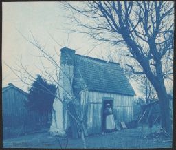 Woman standing in doorway of cabin, Hampton