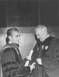 Shah of Iran, Mohammad Reza Pahlavi (1919-1980), LL.D. (hon.) 1962, holding his honorary degree, shakes hands with Penn President Gaylord Harnwell